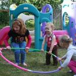 Daycare Children Playing with a Hula Hoop at A Quiet Forest Daycare and Preschool in Duvall WA