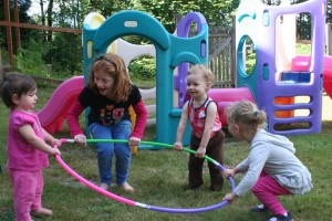 Daycare Children Playing with a Hula Hoop at A Quiet Forest Daycare and Preschool in Duvall WA